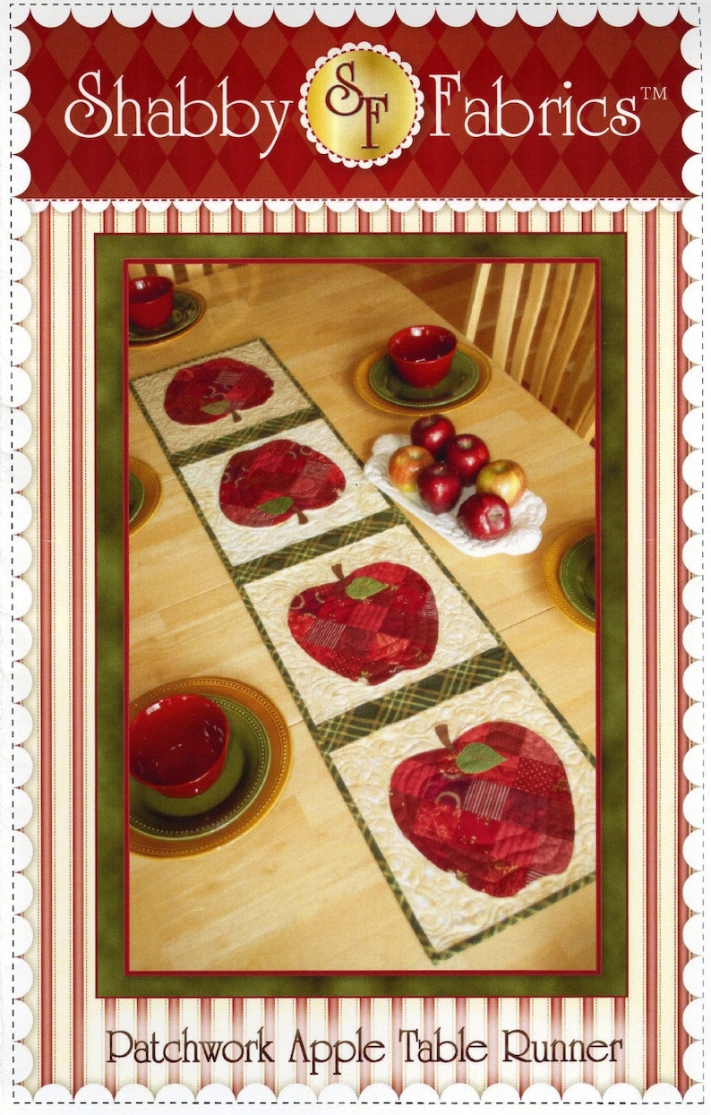 May include: A patchwork apple table runner in a red, green and white colour scheme. The runner is laid out on a wooden table with red bowls and apples on a white plate. The text "Patchwork Apple Table Runner" is at the bottom of the image.