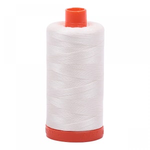 May include: A white spool of thread with an orange plastic top and bottom. The spool is labeled "BREW"