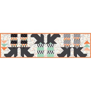 May include: A Halloween-themed quilt runner with a repeating pattern of black, orange, and gray geometric shapes. The runner features a cream-colored background with small Halloween-related illustrations and an orange border.
