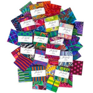 May include: A collection of square fabric swatches featuring a variety of vibrant, multi-coloured patterns including polka dots, stripes, and floral designs. Each stack is secured with a white paper band labelled Free Spirit in black script.