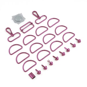 May include: A set of pink metal hardware for crafting projects. The set includes D-rings, swivel clasps, and rivets.