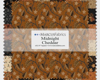 May include: A stack of 42 fabric squares measuring 10 inches each, labeled Marcus Fabrics Midnight Cheddar. The fabric features various patterns in black, tan, and burnt orange, including floral vines, paisley, and small geometric motifs.
