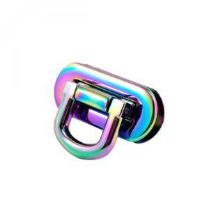 May include: A rainbow iridescent metal clasp with a D-ring. The clasp is oval shaped and has a shiny finish.