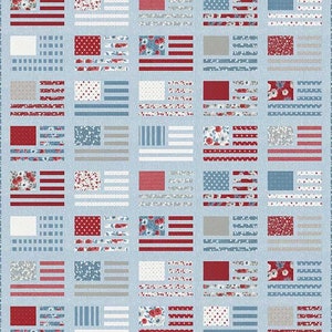 May include: A patchwork quilt featuring a repeating pattern of stylized American flags. Each flag square incorporates red, white, and blue fabrics with floral, polka dot, and striped designs. The quilt has a light blue background.