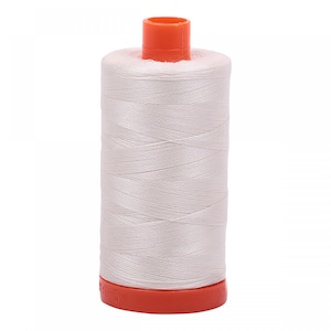 May include: A spool of white thread with an orange plastic bobbin.
