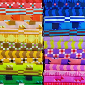 May include: A collection of folded fabric strips arranged in two vertical columns. The fabric features a variety of geometric patterns including stripes, checks, and triangles in a vibrant spectrum of colors such as red, orange, yellow, green, blue, purple, and pink.