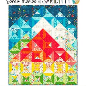 May include: Sandia Peak quilt pattern by Sarah Thomas of Sariditty. The quilt design features a mountain range in shades of red, orange, yellow, blue, and white. Finished size is 46.5" x 54.25". Skill level: Confident Beginner. Layer Cake Friendly.