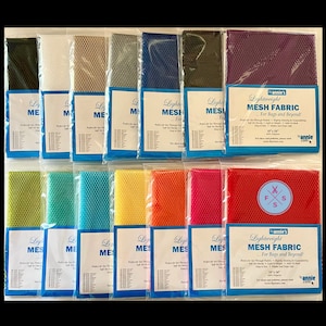 May include: Assortment of 18-inch by 14-inch mesh fabric swatches in various colors, including green, white, beige, gray, blue, dark green, purple, light green, turquoise, blue, yellow, orange, red, and maroon. The fabric is lightweight and perfect for bags and beyond. The text on the packaging reads "Lightweight Mesh Fabric... For Bags and Beyond!"