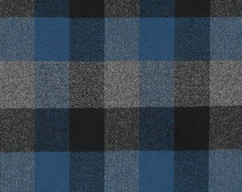 May include: A close-up of a fabric with a large plaid pattern. The pattern features squares in shades of blue, gray, and black. The fabric has a textured appearance, suggesting a woven material like flannel or wool. The design is symmetrical and bold.