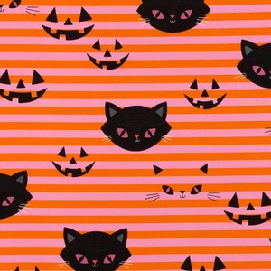 May include: Halloween-themed fabric with a repeating pattern of black cat faces and jack-o'-lanterns. The design features orange and pink horizontal stripes. The cats have pink eyes and white whiskers.