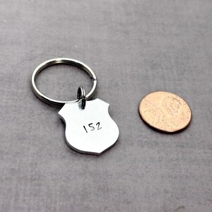 Police Officer gift, customizable police badge keychain next to a penny to show size