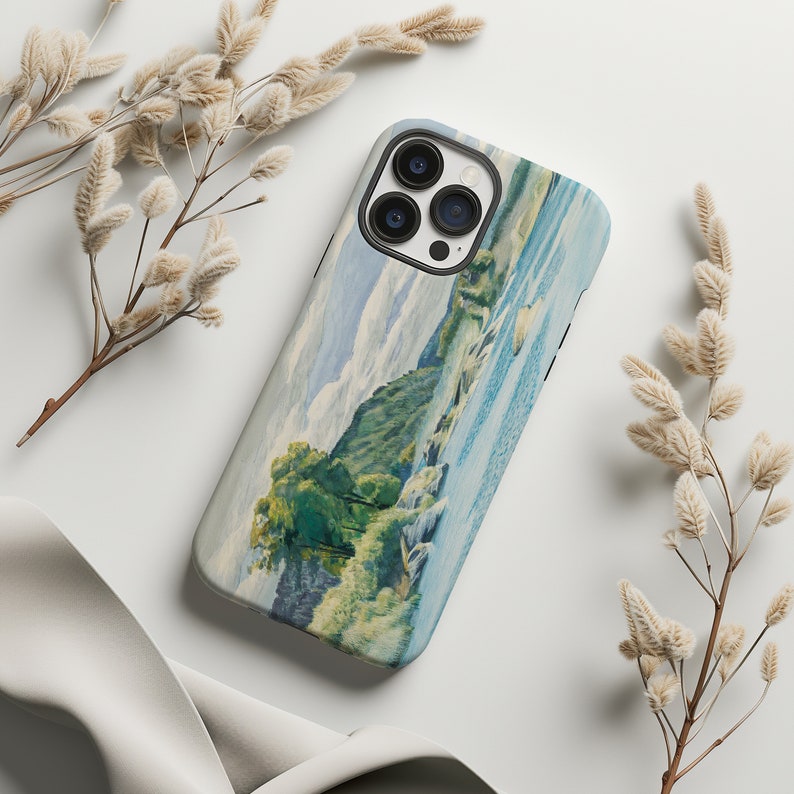May include: A phone case with a watercolor painting of a river scene. The painting features a river with rapids, a green forested area, and a cloudy sky.