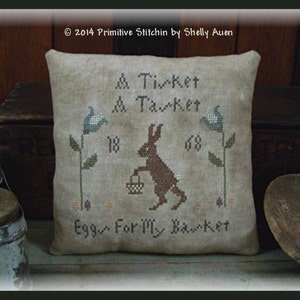 May include: A brown bunny with a basket of eggs, surrounded by flowers and the text "& Ticket A Tarket 18 68 Egg For My Banket".