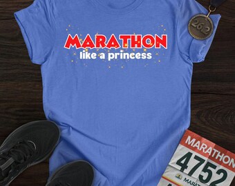 May include: A light blue t-shirt with the text "MARATHON like a princess" in red and white. A marathon medal and race bib are also visible. Black running shoes are at the bottom of the image.