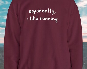 Może przedstawiać: Bordowa bluza z białym napisem "apparently, I like running". Bluza z okrągłym dekoltem jest w jednolitym kolorze i nadaje się do noszenia na co dzień.