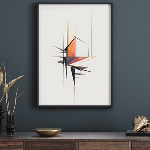 May include: Abstract geometric art print in a black frame. The artwork features a colorful, angular design with orange, blue, and black shapes. The print is displayed on a dark blue wall above a wooden cabinet with decorative items.
