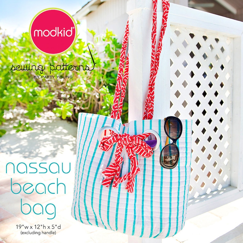 May include: A striped beach bag with red and white handles, a red bow, and sunglasses. The bag is 19 inches wide, 12 inches high, and 5 inches deep, excluding the handle. The text "Nassau beach bag" is printed on the front of the bag.