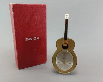 Orologio da scrivania meccanico vintage SWIZA a forma di chitarra, sveglia musicale di fabbricazione svizzera, con scatola originale.
