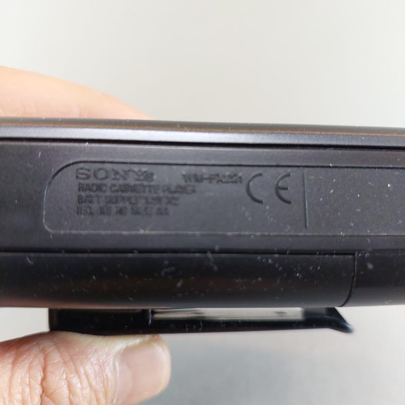 May include: Close-up of a black Sony Radio Cassette Player. The text on the device includes the brand name, model number, and other technical specifications. A CE mark is also visible.