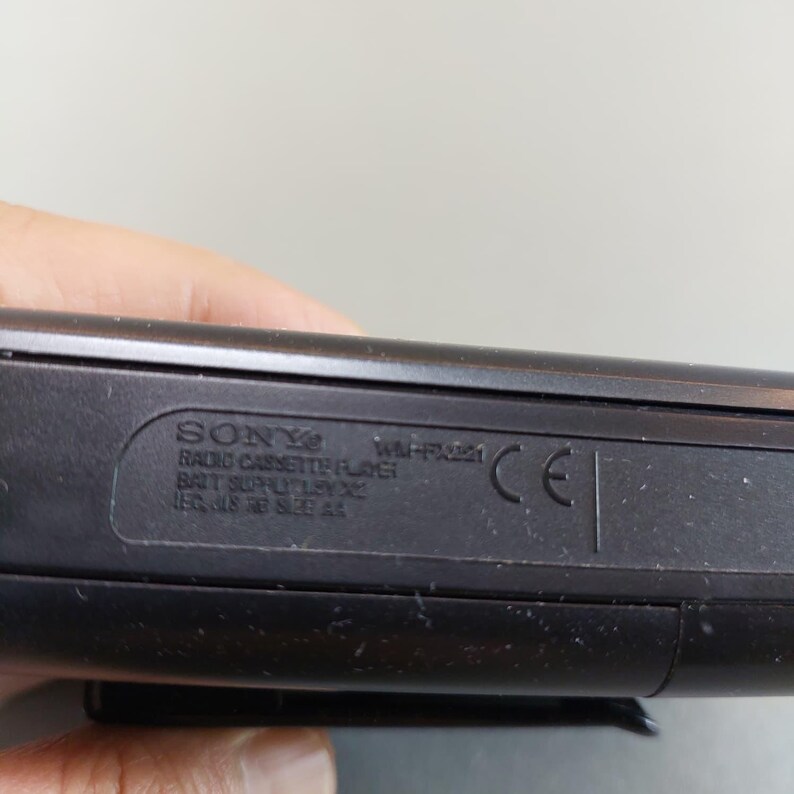 May include: Close-up of a black Sony radio cassette player. The text on the device includes "SONY", "WM-FX421", and other technical specifications. The device has a CE marking.