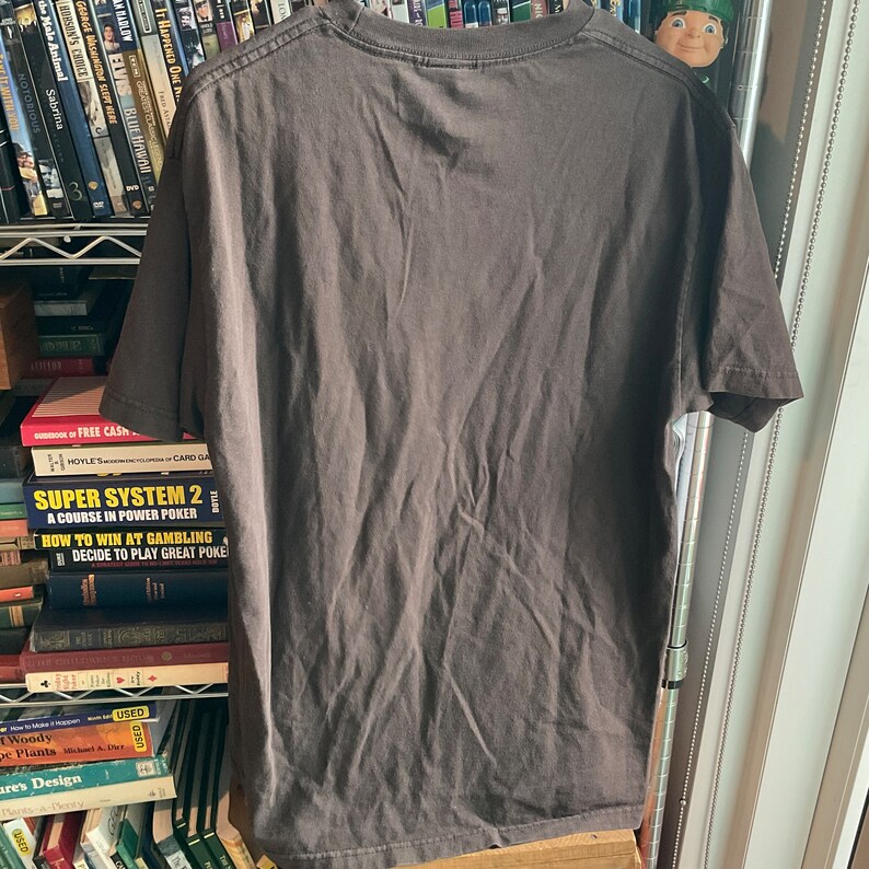 May include: A dark gray t-shirt with short sleeves and a crew neck. The shirt is made of a soft, comfortable material.