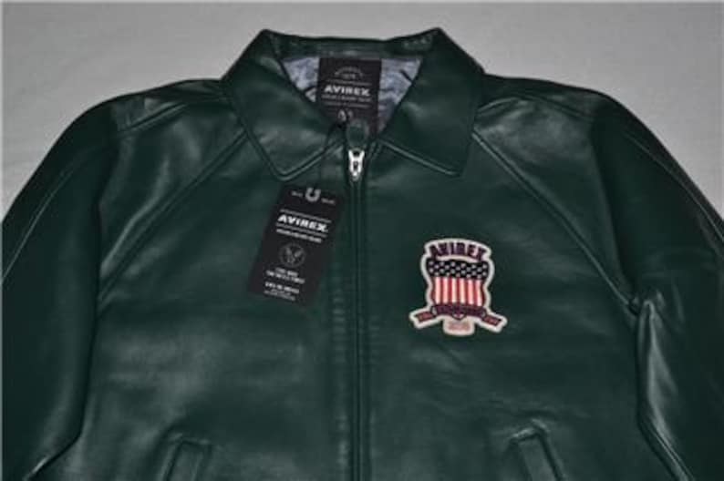 May include: A set of three ceramic mugs with a speckled, cream-colored glaze. Each mug features a different hand-painted floral design in shades of blue, green, and yellow. The mugs have a simple, rounded shape and a comfortable handle.