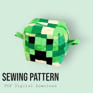 May include: A green and black square-shaped zippered pouch with a pixelated design, resembling a popular video game character. The pouch has two small fabric handles and the text "SEWING PATTERN" and "PDF Digital Download".