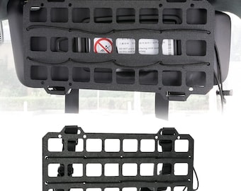 May include: Black overhead console organizer with a grid pattern and elastic straps. The organizer is designed to fit in a car and has a warning label that says "DO NOT place on this seat w/ facing child seat airbag".