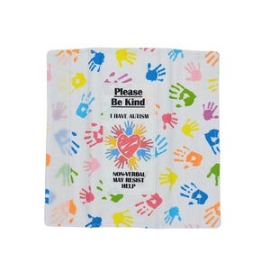 May include: White cloth with colorful handprints and text. The center features a heart and the words "Please Be Kind, I Have Autism, Non-Verbal May Resist Help."