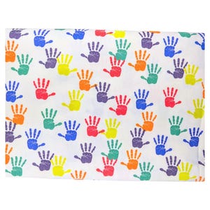 May include: White fabric with a repeating pattern of colorful handprints in red, orange, yellow, green, blue, and purple. The handprints are evenly spaced across the fabric.