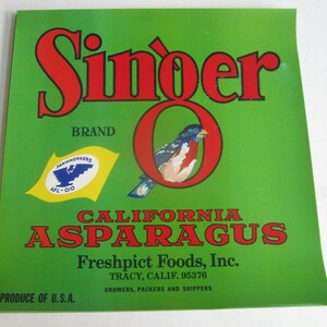 May include: A vintage green label for "Singer" brand California asparagus. The label features red text, a bird illustration inside a red "O", and the Farmworkers AFL-CIO logo. The text includes "Freshpict Foods, Inc."