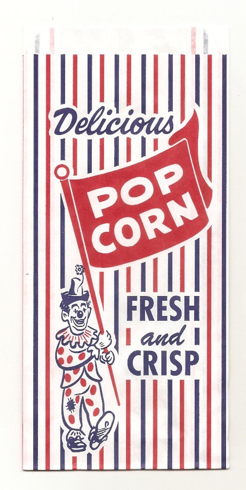 May include: A vintage popcorn bag with red and white stripes. The bag features a red banner with the words "POP CORN" in white letters. A clown with a red nose and polka dot clothing is holding a stick with a flower on top. The text "Delicious" is at the top of the bag and "Fresh and Crisp" is at the bottom.