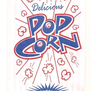 May include: A white paper bag with red and white stripes. The bag has a blue and red illustration of popcorn with the text "Delicious Popcorn" and "Fresh! Ready to Eat!"