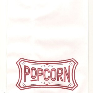 May include: A white paper bag with a red and white "POPCORN" logo printed on the front.