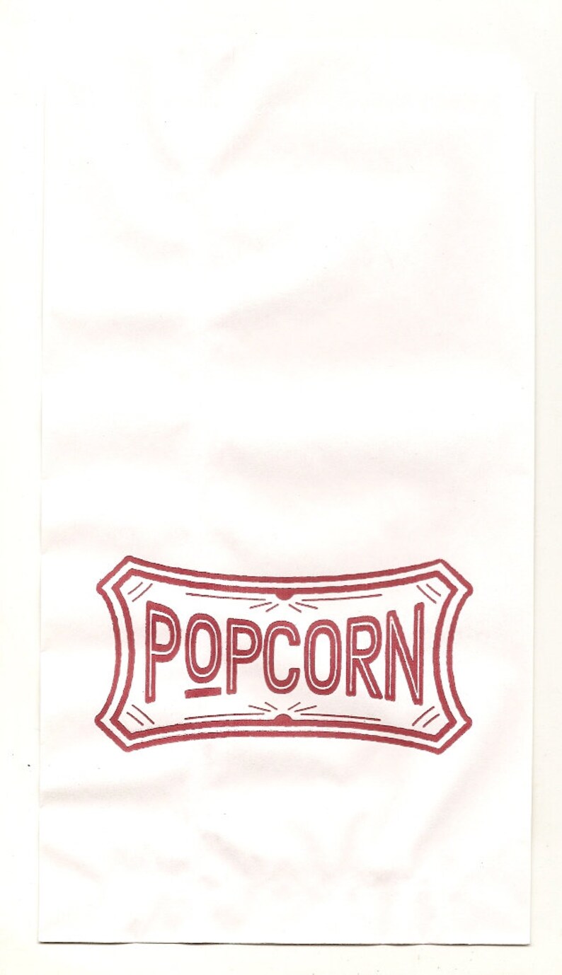 May include: A white paper bag with a red and white "POPCORN" logo printed on the front.