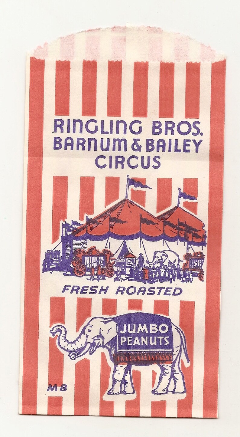 May include: A red and white striped paper bag with the text "Ringling Bros. Barnum & Bailey Circus" printed in purple. The bag also features an illustration of a circus tent and a cartoon elephant wearing a sign that says "Jumbo Peanuts". The text "Fresh Roasted" is printed below the circus tent.