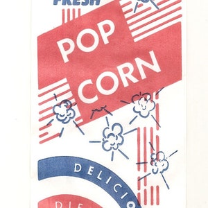 May include: A vintage popcorn bag with red and blue stripes and a red banner that says "FRESH POP CORN". The bag also has a blue and red circle that says "DELICIOUS DIFFERENT".