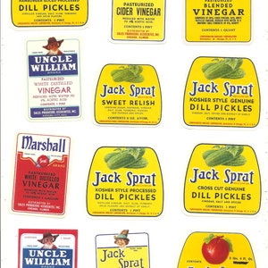 May include: A collection of vintage Jack Sprat brand food labels featuring various products like dill pickles, sweet relish, and vinegar. The labels are yellow with blue and red accents and feature a cartoon character.