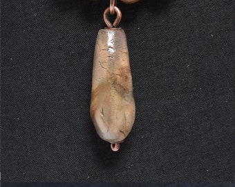 sagger fired ceramic pendant 8 with copper, wood and leather cord.