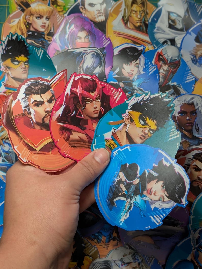 May include: A collection of colourful character stickers featuring various characters with different hairstyles, clothing, and expressions. The stickers are round and have a glossy finish.