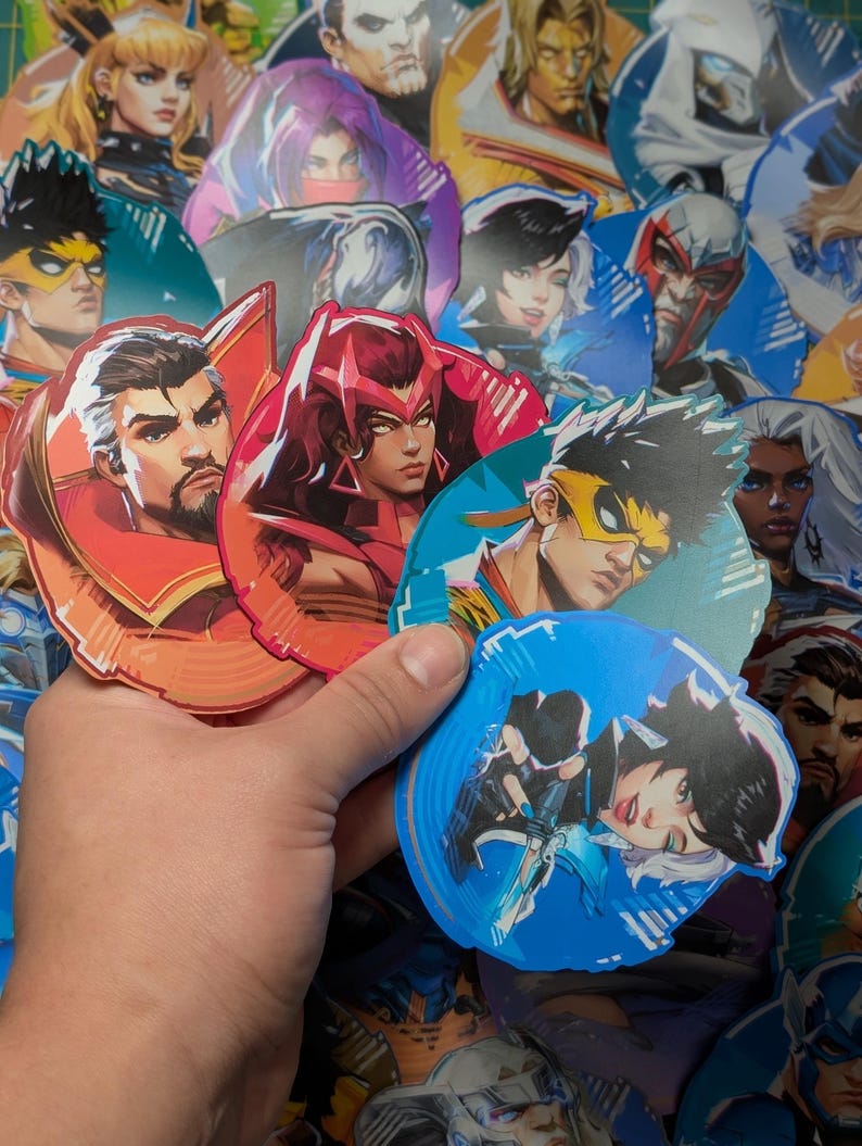 May include: A collection of colourful round stickers featuring various characters from a video game. The stickers are printed on glossy paper and have a holographic finish. The characters are depicted in a variety of poses and expressions, and the stickers are perfect for adding a touch of personality to laptops, water bottles, or other items.