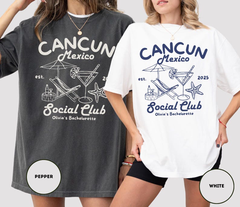 May include: Two oversized t-shirts with a graphic design featuring a beach scene with a cocktail, lounge chair, and palm tree. The text on the shirts reads "CANCUN Mexico Social Club Olivia's Bachelorette" with the year "2025" on the white shirt. The shirts are shown on models wearing black shorts. The shirt on the left is a dark gray color and the shirt on the right is white.