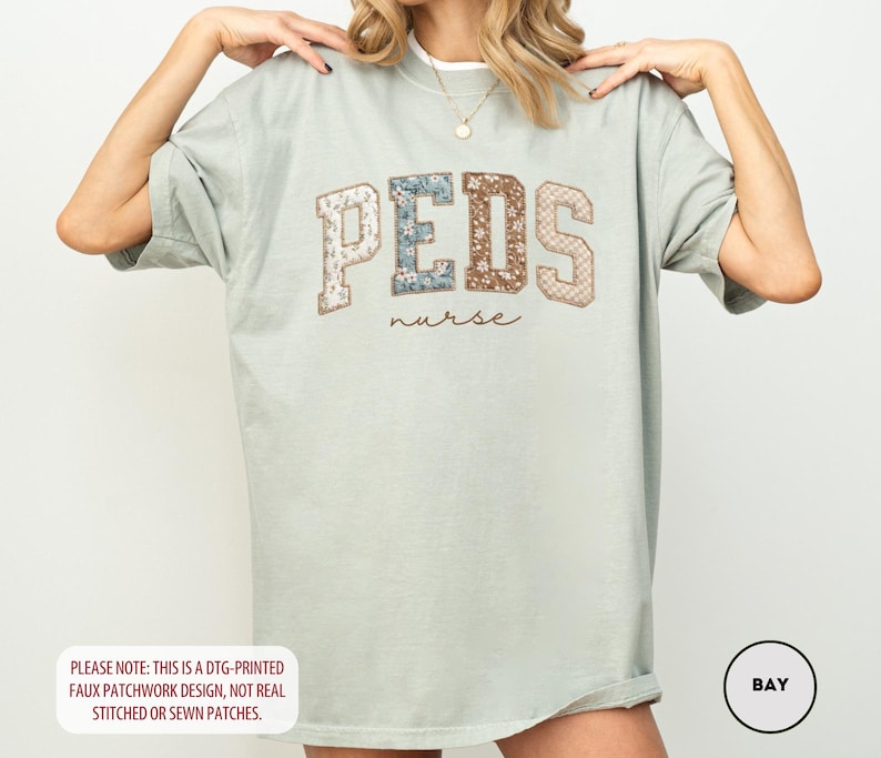 May include: A light green t-shirt with the word "PEDS" in a patchwork design, with the word "nurse" below it. The shirt has short sleeves and a relaxed fit. The text "PLEASE NOTE: THIS IS A DTG-PRINTED FAUX PATCHWORK DESIGN, NOT REAL STITCHED OR SEWN PATCHES." is at the bottom.