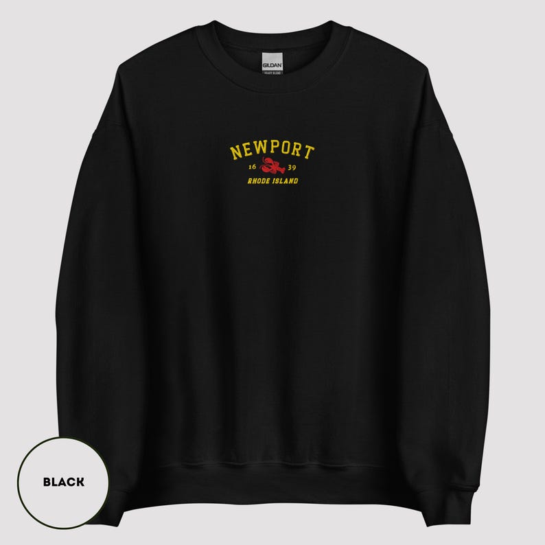 May include: Black sweatshirt featuring the word "NEWPORT" in yellow arched text above a red lobster graphic. Below the lobster are the numbers "16" and "39" and the words "Rhode Island" in yellow text. The sweatshirt is a Gildan brand.