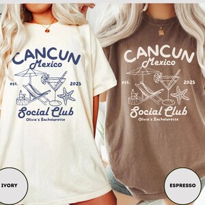 May include: Two t-shirts with a graphic design of a beach scene with a cocktail, lounge chair, and a starfish. The text on the shirts reads "Cancun Mexico est. 2025 Social Club Olivia's Bachelorette". The shirts are in ivory and espresso colors.