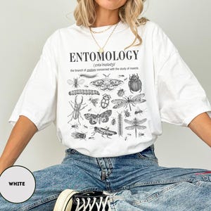 May include: White t-shirt with a black and white illustration of various insects and the text "ENTOMOLOGY /ˈɛntəˈmɒlədʒi/ the branch of zoology concerned with the study of insects"