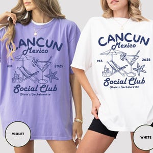 May include: Two oversized t-shirts with a graphic design featuring a cocktail, lounge chair, and palm tree. The text on the shirts reads "CANCUN Mexico est. 2025 Social Club Olivia's Bachelorette". The shirts are shown in violet and white.