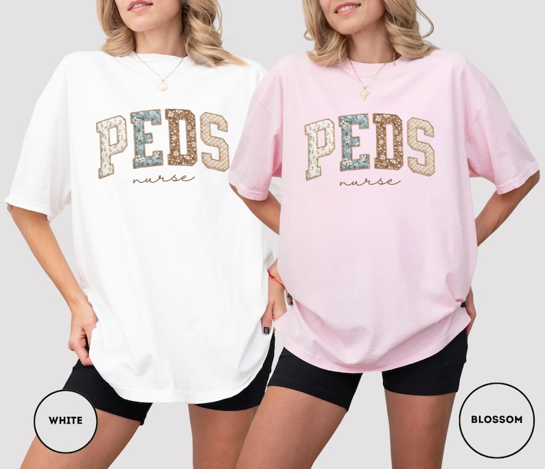 May include: Two oversized t-shirts, one white and one pink, featuring the text "PEDS nurse" in a collegiate-style design. The letters have a floral pattern. The shirts are worn with black shorts.