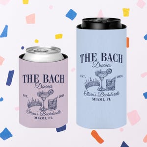 May include: Two insulated can coolers with a light blue and a light purple background. Both coolers feature the text "THE BACH Diaries" with a crown and two cocktail glasses. The text "EST. 2025" is also included on both coolers. The light blue cooler has the text "Olivia's Bachelorette MIAMI, FL".