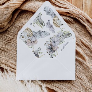 May include: White envelope with a floral pattern on the inside flap. The pattern features watercolor illustrations of seashells, seaweed, and other ocean-inspired elements in shades of blue, green, and pink.